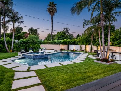 Backyard pool in a verdant garden setting in a modern new construction home in Los Angeles A backyard pool in a verdant garden setting in a modern new construction home in Los Angeles